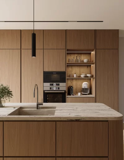 Cozinha do projeto The Duneview House, com ilha central, carpintarias em nogueira mate e mármore travertino com veios horizontais.