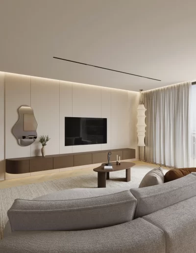 Sala de estar no projeto The Duneview House, com sofá orgânico em tecido claro, candeeiro escultórico suspenso e móvel TV flutuante.
